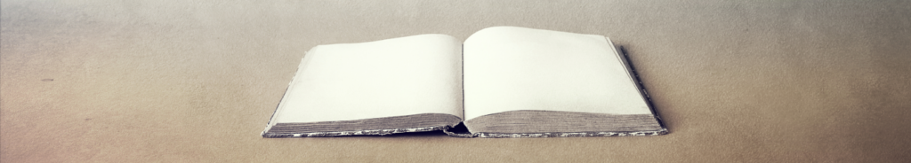 an open and worn book, displays it's blank pages