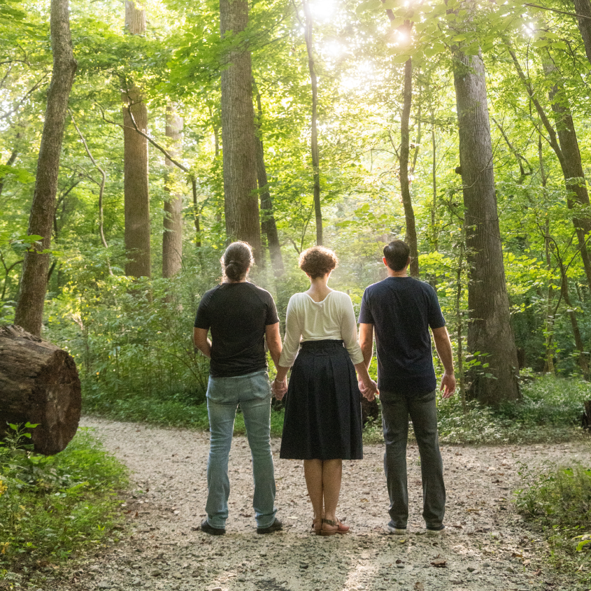 Thomas Bell, Ryan Klee, and Terra Elan McVoy facing into the forest