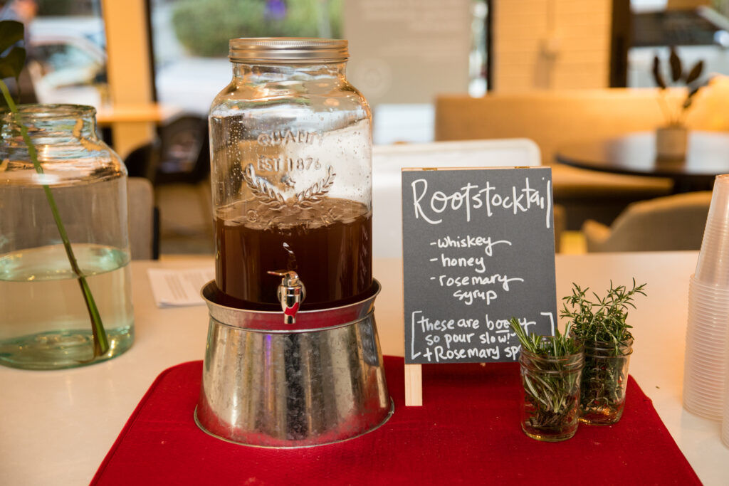 The "Rootstocktail," a whiskey drink with honey and rosemary syrup, with sprigs of rosemary to garnish.
