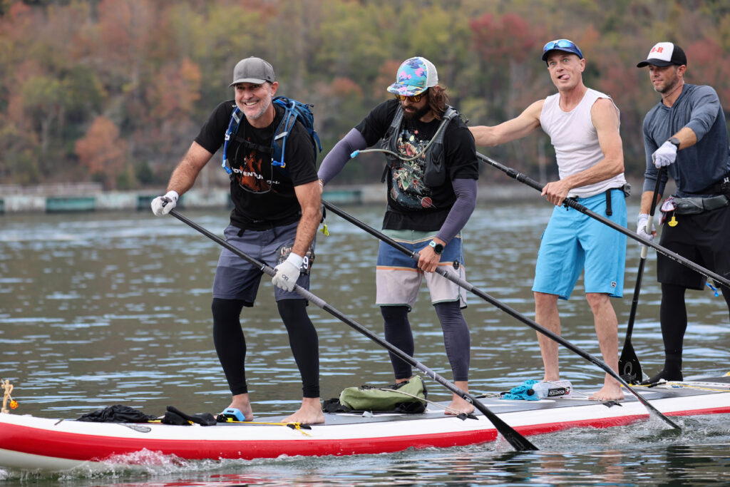 Four paddle boarders on one paddle board finish the 2022 Chattajack race.